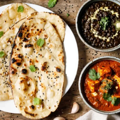 Garlic naan served with dal makhani and paneer curry